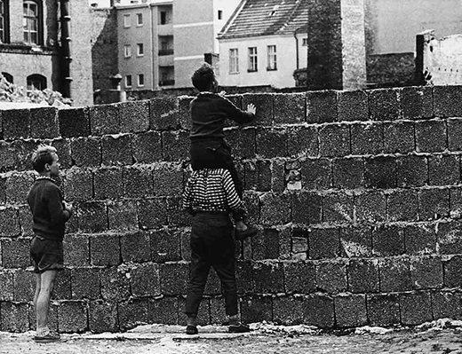 Peering over Berlin Wall Photograph